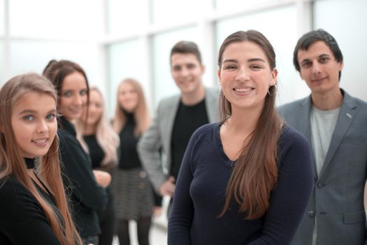 image of a young employee standing among her colleagues. office workdays