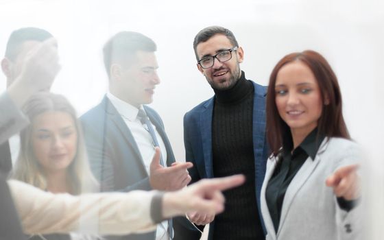 businesswoman pointing to an ad on a glass Board. business concept