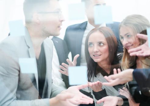 through the glass. young employees discussing sticky bunnies