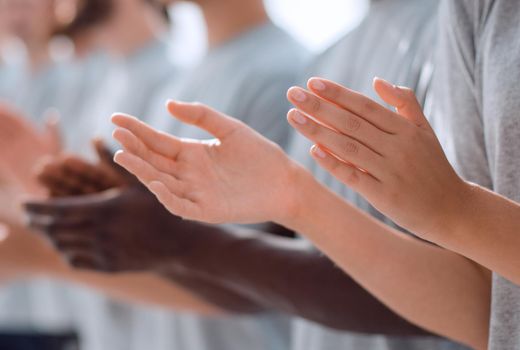 close up.image a group of young people standing in a row applauding. photo with copy space