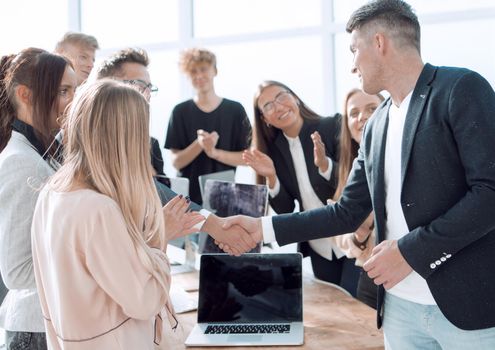 happy employees congratulating each other on their success. business concept