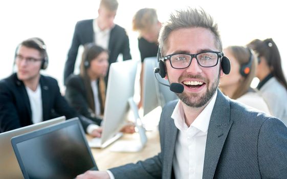 close up. happy man in headset looking at camera. the concept of e-business