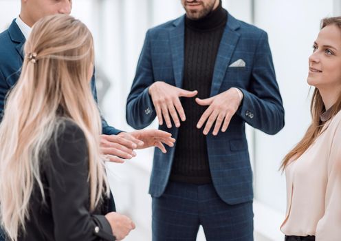 close up . agroup of employees talking standing in the office. team work