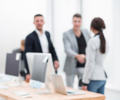 blurry image of employees at their workplace in the office. business background