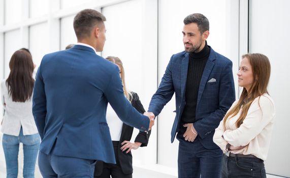 close up. business partners holding out their hands for a handshake