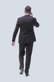 side view. modern businessman talking on mobile phone. isolated on white background