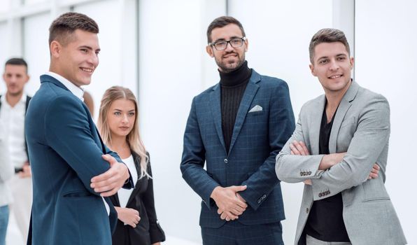 group of young employees standing in the office. office workdays