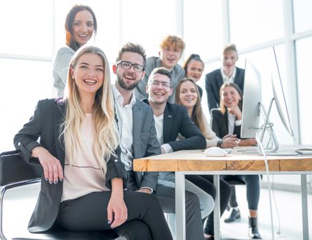 young business woman sitting in front of a big business team. the concept of teamwork