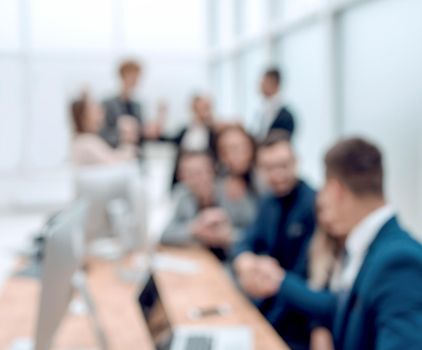 blurry image of a happy business team in the workplace. business background