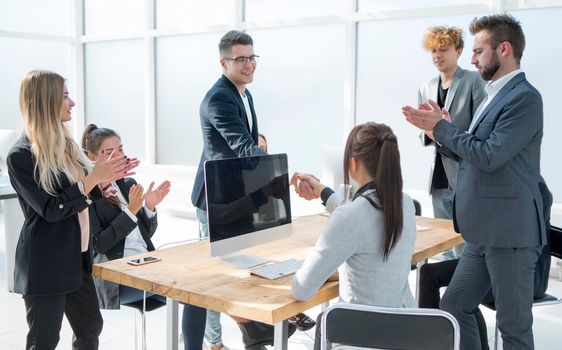 Manager shaking hands with an employee during a work meeting. success concept