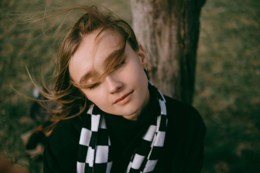 portrait of a girl close up. hair flutters in the wind. green