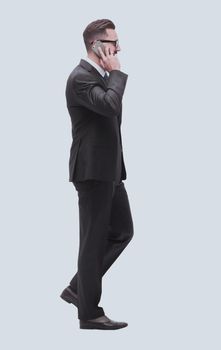 side view. businessman talking on his smartphone . isolated on white background