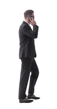 side view. businessman talking on his smartphone . isolated on white background