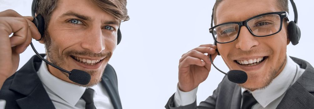 handsome young man in work in call-centre with headphones and smiling