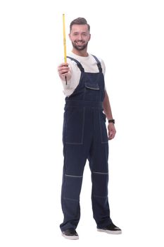 in full growth. a man in overalls with a construction tape measure. isolated on white background