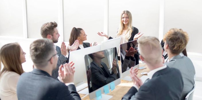 business team applauding the speaker at a working meeting. the concept of teamwork