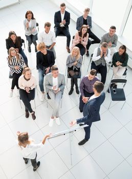 top view. listeners applauding the speaker at a business seminar. business and education