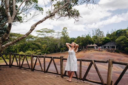 a girl against the background of seven-colored lands in Mauritius, a nature reserve, Chamarel sands.Mauritius Island.