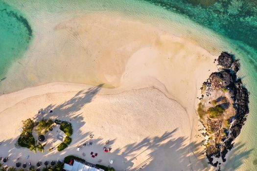 View from the height of the east coast of the island of Mauritius. Flying over the turquoise lagoon of the island of Mauritius in the area of Bel Mare