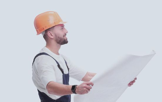 in full growth. competent foreman Builder looking at drawings. isolated on white background