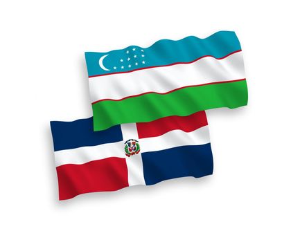 National fabric wave flags of Dominican Republic and Uzbekistan isolated on white background. 1 to 2 proportion.