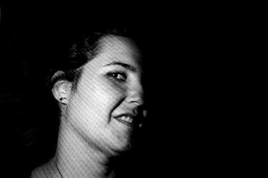 Portrait of the face of a young woman smiling in the foreground in a photographic studio. happy people concept