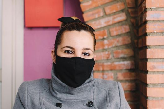 Beautiful Women In A Medical Mask. Close-up of a young woman with a surgical mask on her face against SARS-cov-2.