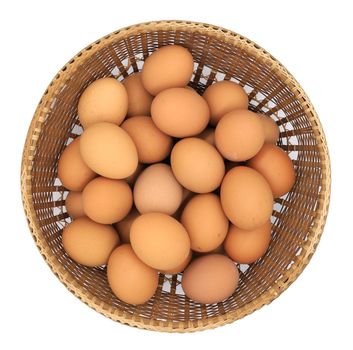 Eggs in basket isolated on white background