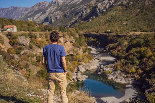 Montenegro. man tourist on the background of Clean clear turquoise water of river Moraca in green moraca canyon nature landscape. Travel around Montenegro concept.