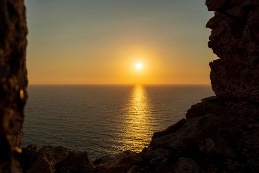 Beautiful sunset above the sea from Palaiokastro castle of ancient Pylos. Greece. Palaiokastro was built in the 13th century A.D. by the Franks.