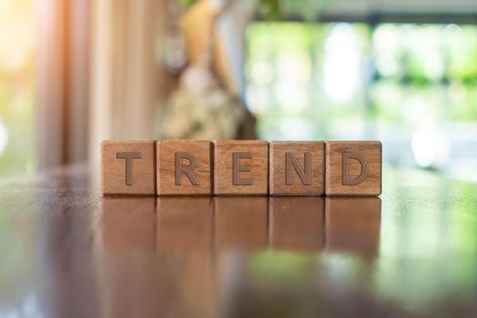 A group wooden cubes on table with word Trend on it background.