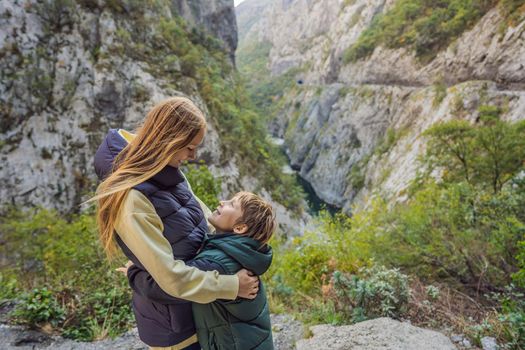 Mom and son tourists in the background of Beautiful Canyon of Moraca river in winter, Montenegro or Crna Gora, Balkan, Europe.