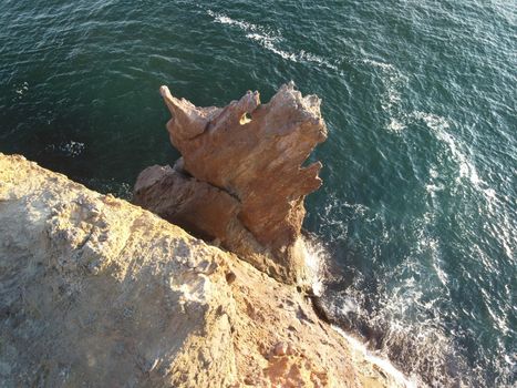 The rock or lava formation with the shape of a large animal or dragon head arise from the water. Popular travel destination volcanic rock formation in the shape of a dragon's head. Crimea, Fiolent