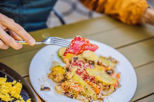 Grilled colorful vegetable : bell pepper, zucchini, eggplant on a plate over light grey slate, stone or concrete background.