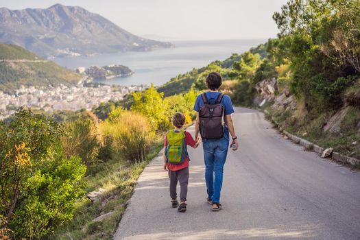 Happy family on the background of Panoramic view of the city of Budva, Montenegro. Beautiful view from the mountains to the Adriatic Sea.