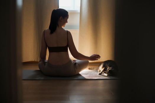 fitness yoga training workout. young woman doing exercises at home. meditation and mental health concept