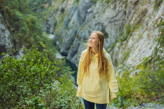 Woman tourist in the background of Beautiful Canyon of Moraca river in winter, Montenegro or Crna Gora, Balkan, Europe.