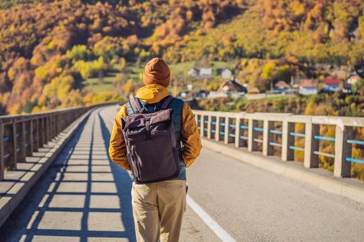 Montenegro. Man touriste in background of Dzhurdzhevich Bridge Over The River Tara foggy morning. Travel around Montenegro concept. Sights of Montenegro.