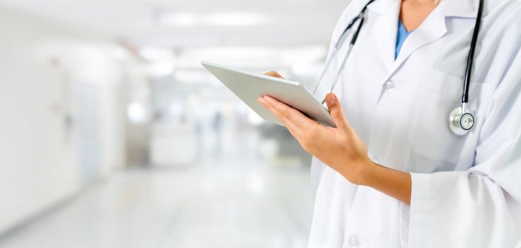 Doctor using tablet computer at the hospital. Medical healthcare and doctor staff service.