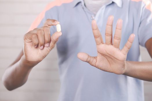 upset man hand holding medical pills .