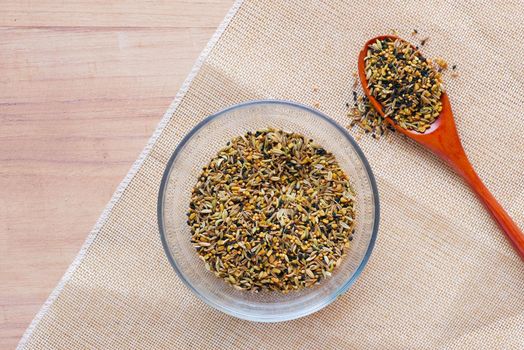 mixed of different spice on a bowl on table .