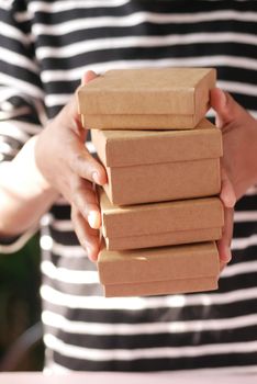 hand hold stack of homemade gift box .