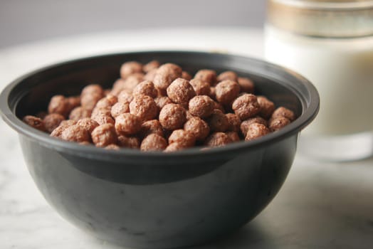 chocolate corn flakes in a bowl on table ,