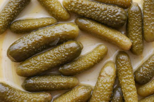 pickled cucumbers on a plate .