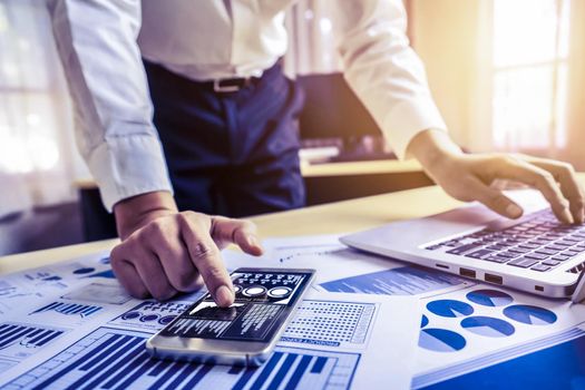 Businessman accountant or financial expert analyze business report graph and finance chart at corporate office. Concept of finance economy, banking business and stock market research.