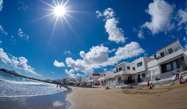 17 February 2022 Playa Ojos de Garza Canary Spain,a small beach cozy to the ocean near the airport with colorful houses near which the tide comes in close