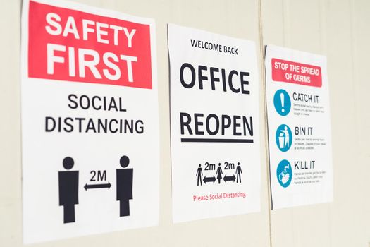 Sign caution in factory warning to industry labor worker to prevent Covid-19 Coronavirus spreading during job business reopening period after epidemic crisis . Working safely concept .