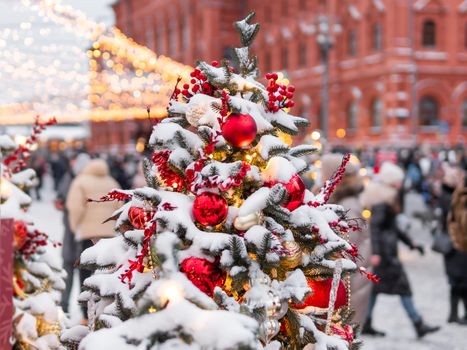 Christmas tree with colorful outdoor decorations. Fir tree decorated with light bulbs for New Year celebration. Moscow, Russia.