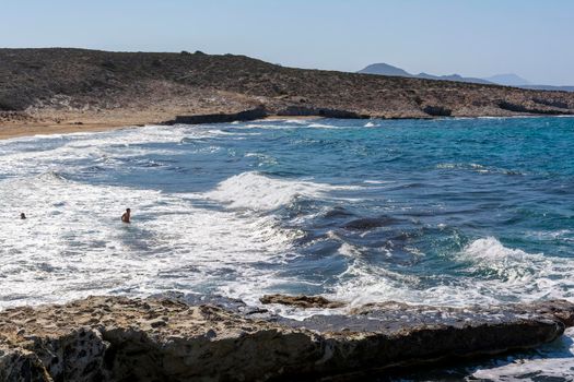 View of Milos island sea with rocks and waves