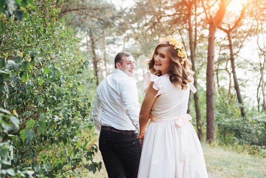 Happy couple in a pine forest. Beauty world